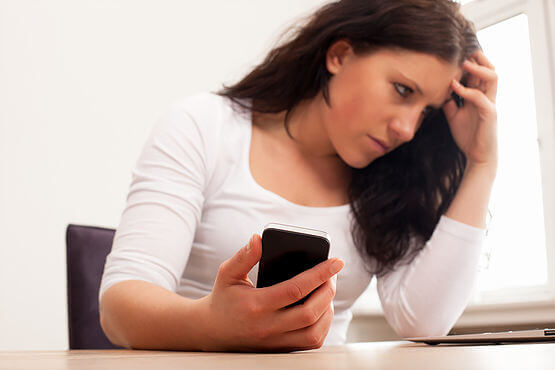 Frustrated Woman Holding Her Phone